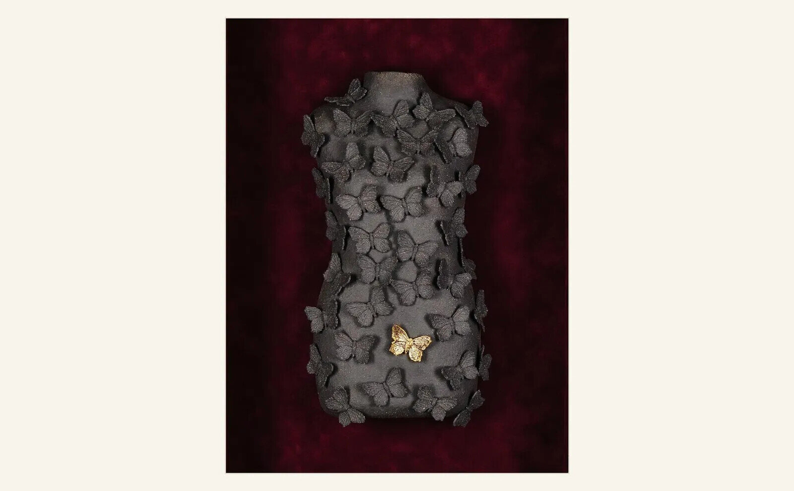 Oliver Akdeniz, Freedom I, a dark wall-mounted ceramic sculpture with small pale organic elements.