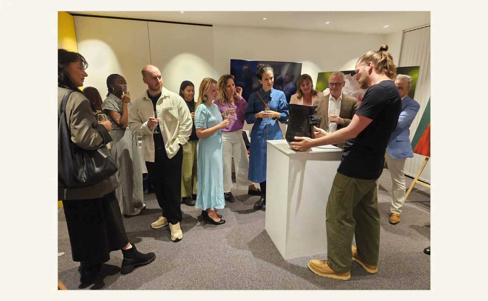 Collectors and visitors listening to an artist talk among contemporary paintings and sculpture at The Story Within the Material, World’s End Studios, September 2025.